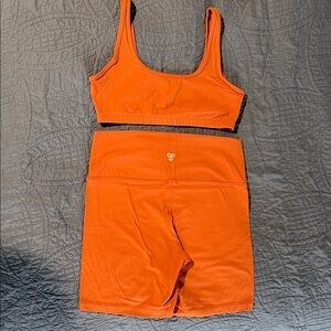 TNA Aritzia (burnt) Orange Sports Bra and Shorts Set. Bra is med, shorts Large